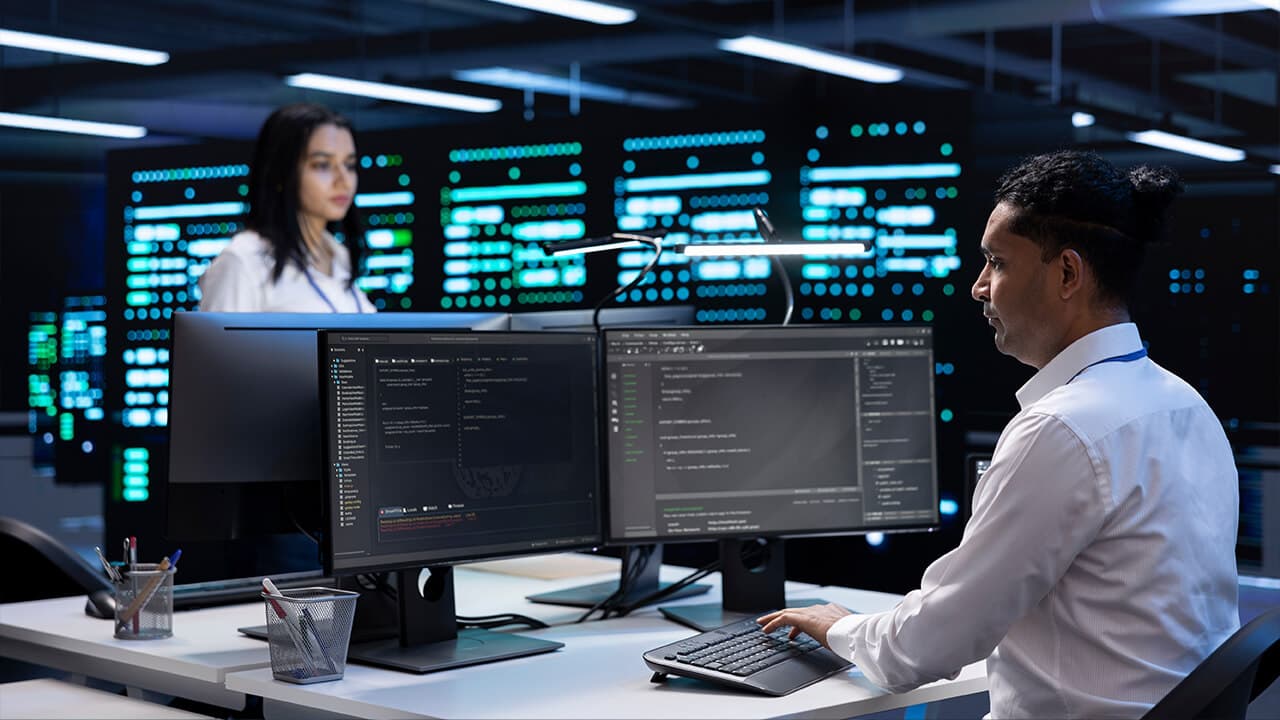 Team working with AI tools on multi-monitor workstations